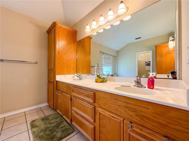 bathroom with tile patterned flooring, lofted ceiling, and vanity