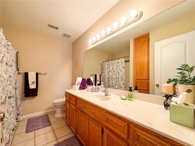 bathroom featuring vanity, tile patterned flooring, and toilet