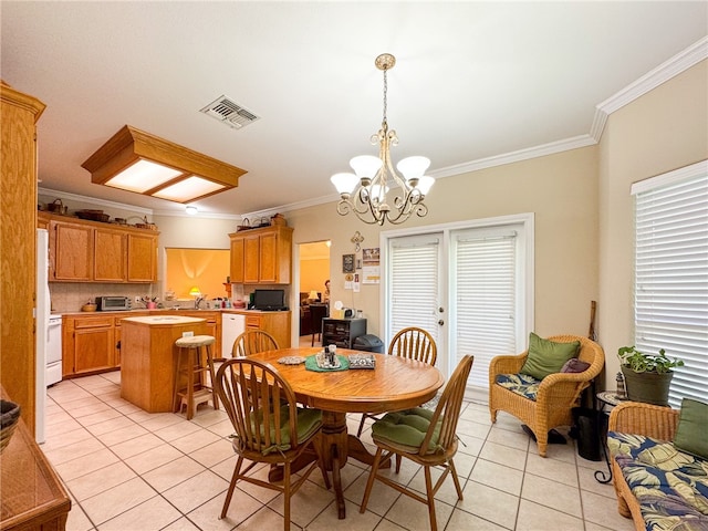 tiled dining room featuring a notable chandelier, sink, and crown molding