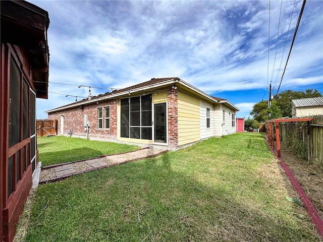 back of house with a lawn