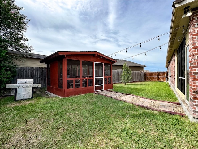 back of house with a sunroom and a yard