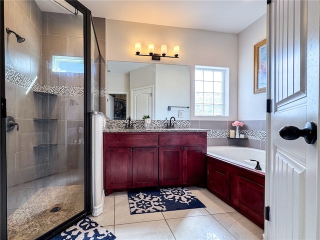 bathroom with independent shower and bath, vanity, and tile patterned floors