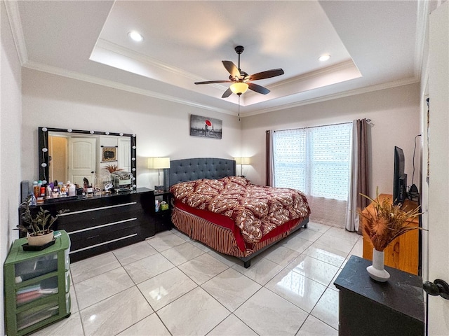 tiled bedroom featuring ceiling fan, a raised ceiling, and ornamental molding