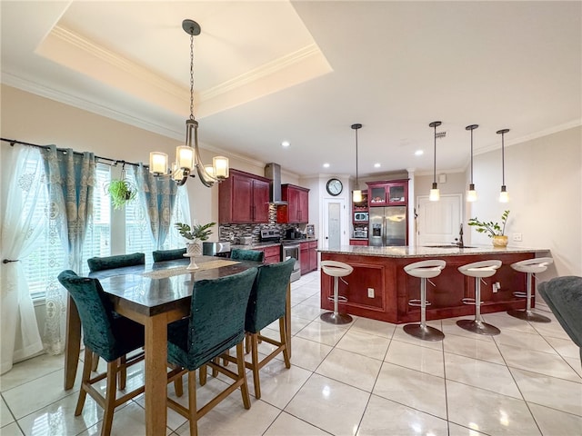 dining room with light tile patterned floors, a chandelier, sink, and crown molding