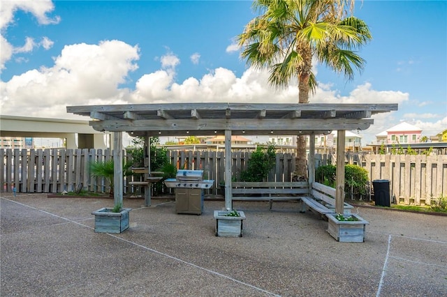 view of property's community featuring a patio area, fence, and a pergola