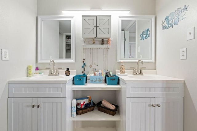 full bath featuring two vanities and a sink