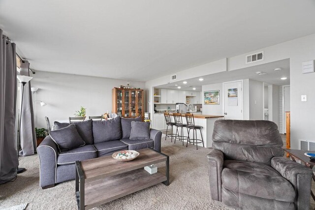 living room with light carpet and visible vents