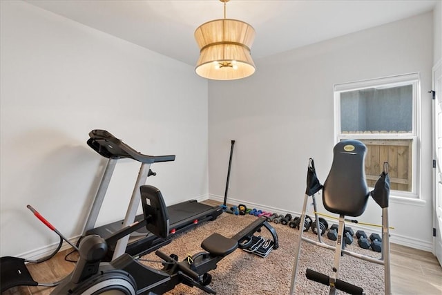 workout room with light hardwood / wood-style floors