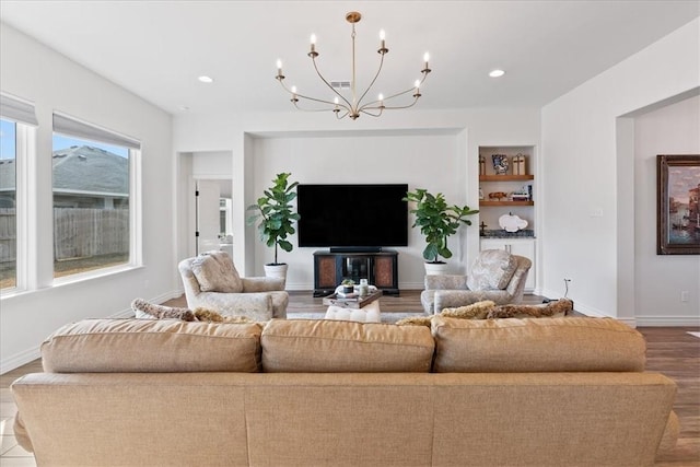 living room featuring hardwood / wood-style flooring and built in features