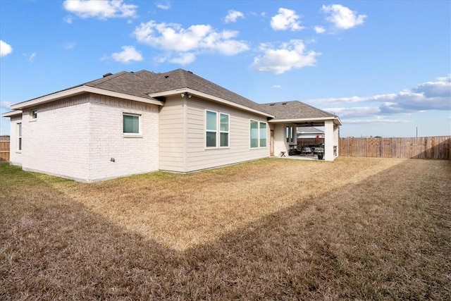 back of house with a yard and a patio