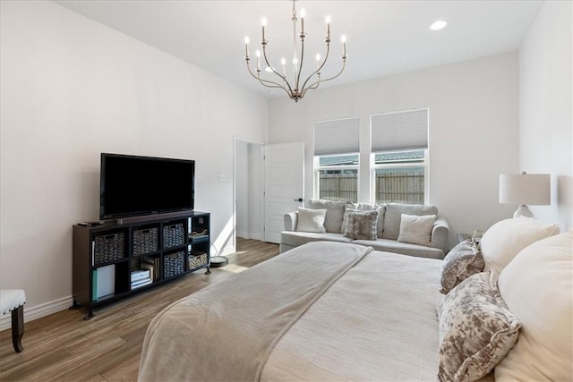 bedroom featuring an inviting chandelier and hardwood / wood-style floors