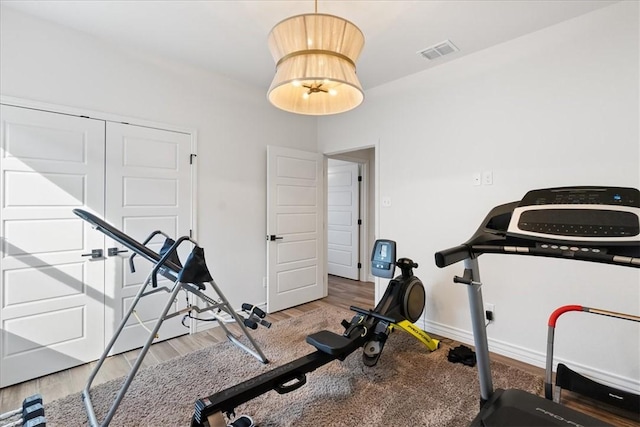 workout area with hardwood / wood-style floors