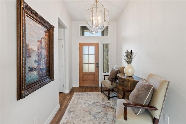 foyer with dark hardwood / wood-style flooring and an inviting chandelier