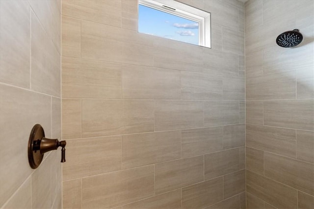 interior details featuring a tile shower