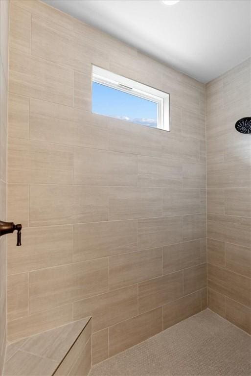 bathroom with a tile shower