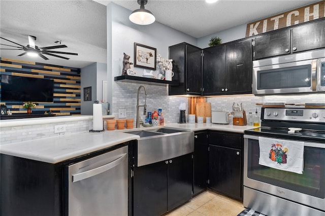 kitchen featuring appliances with stainless steel finishes, a textured ceiling, and backsplash