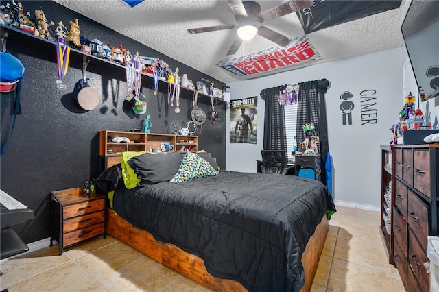 tiled bedroom featuring a textured ceiling and ceiling fan