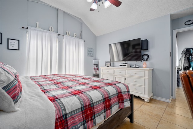 bedroom with ceiling fan, light tile patterned flooring, lofted ceiling, and a textured ceiling