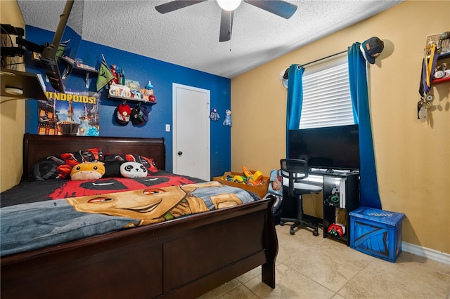 bedroom featuring tile patterned flooring, ceiling fan, and a textured ceiling