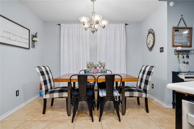 dining room with light tile patterned floors, a textured ceiling, and an inviting chandelier