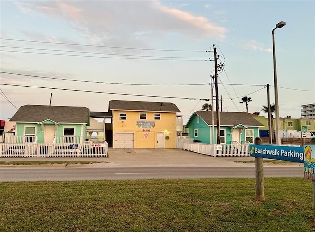 exterior space featuring a garage and a front lawn