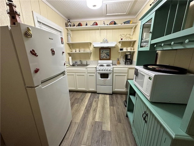 kitchen with light hardwood / wood-style floors, white cabinets, sink, ornamental molding, and white appliances