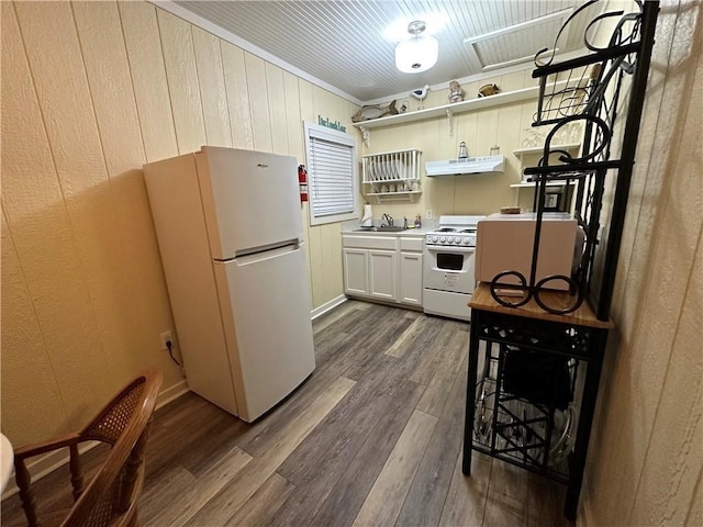 kitchen with sink, dark hardwood / wood-style floors, crown molding, white cabinetry, and white appliances