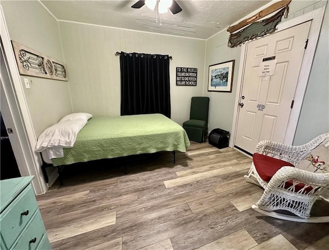 bedroom with light hardwood / wood-style floors and ceiling fan