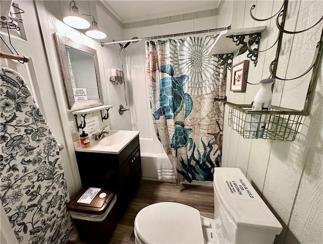 full bathroom with hardwood / wood-style flooring, vanity, shower / bathtub combination with curtain, and toilet