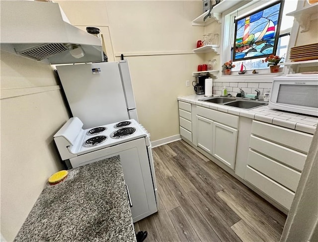 kitchen with ventilation hood, white cabinetry, dark hardwood / wood-style floors, tile countertops, and white appliances