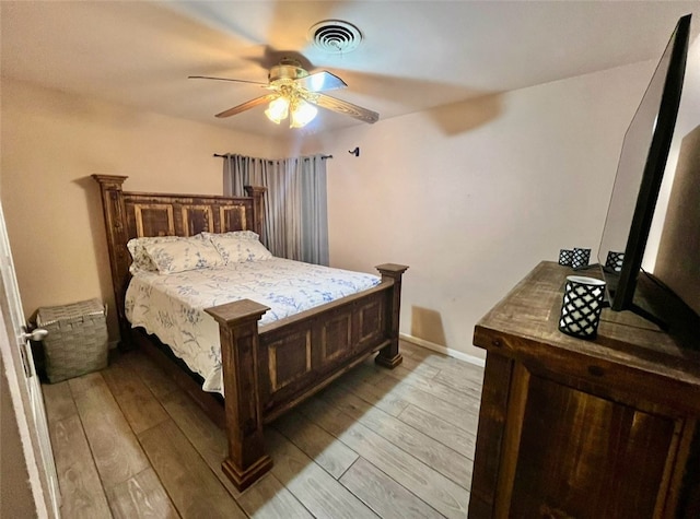 bedroom with ceiling fan and light hardwood / wood-style floors