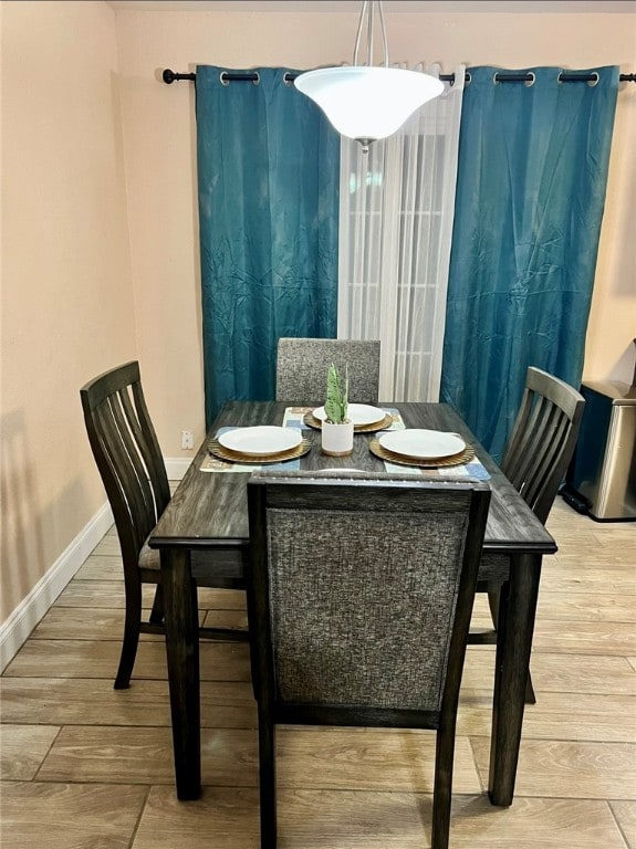 dining area with hardwood / wood-style floors