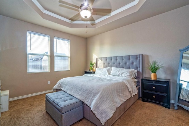 carpeted bedroom with crown molding, a raised ceiling, and ceiling fan