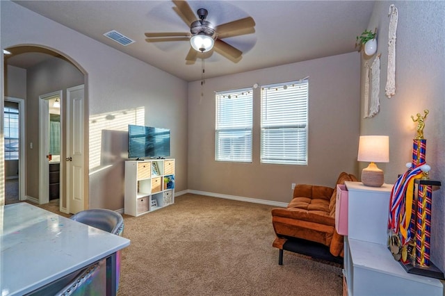 sitting room featuring ceiling fan and light carpet