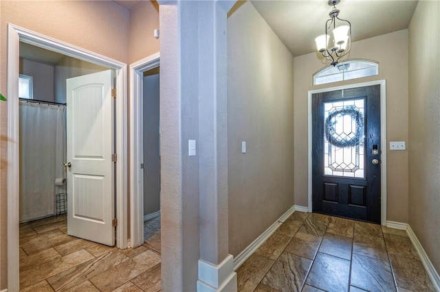 foyer with an inviting chandelier