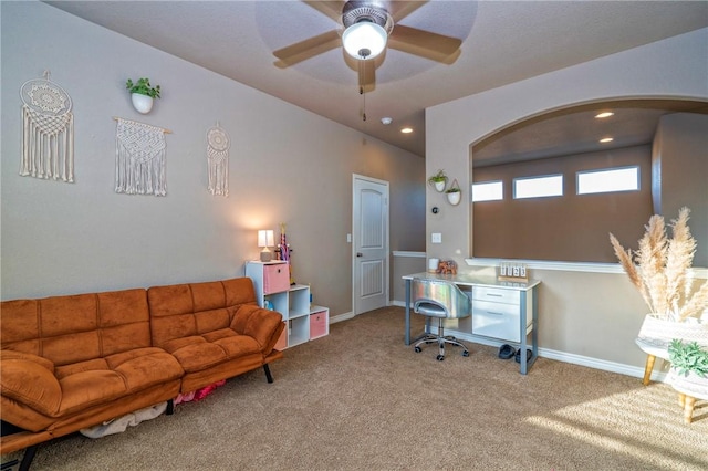 carpeted office featuring ceiling fan