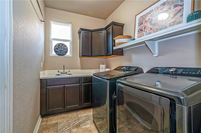 washroom with cabinets, separate washer and dryer, sink, and a textured ceiling