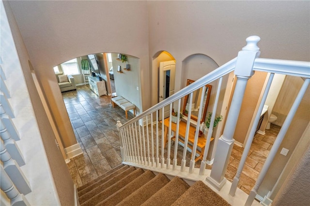 staircase with a towering ceiling