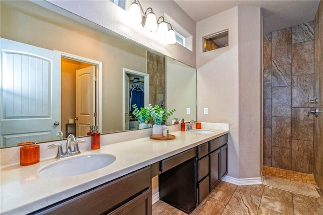 bathroom featuring vanity and tiled shower