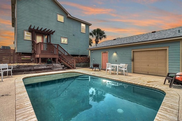 back house at dusk with a patio area