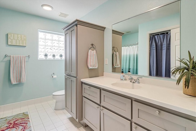 bathroom with tile patterned flooring, vanity, and toilet