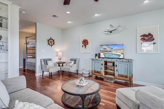 living room with hardwood / wood-style flooring and built in features