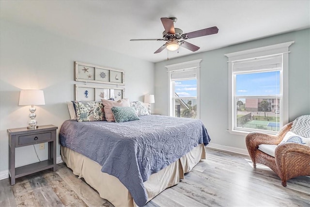 bedroom featuring ceiling fan and light hardwood / wood-style flooring