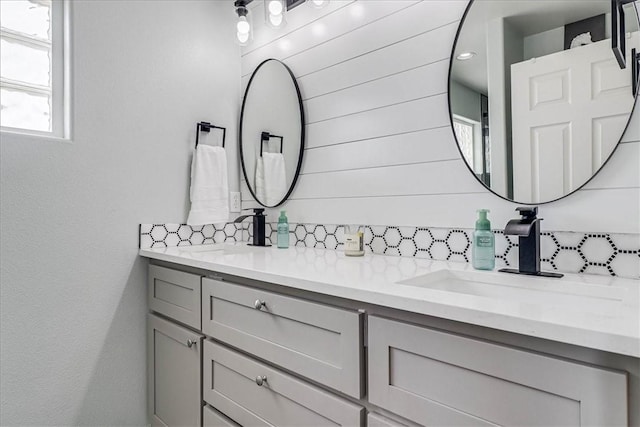 bathroom with vanity and backsplash