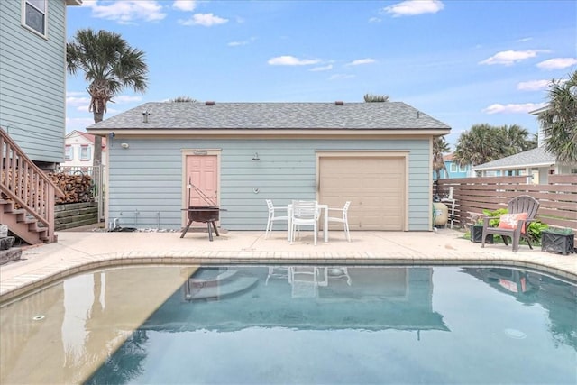 back of property featuring a fenced in pool and a patio