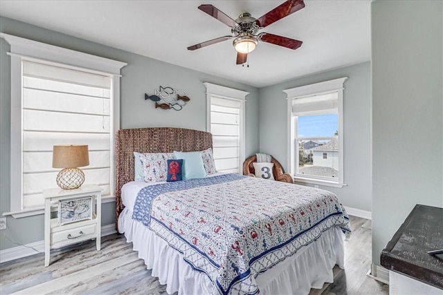 bedroom with light wood-type flooring and ceiling fan