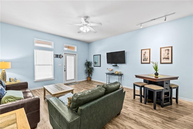 14915 Island Village Dr, Corpus Christi, TX 78418 - living room with rail lighting, ceiling fan, wood finished floors, and baseboards