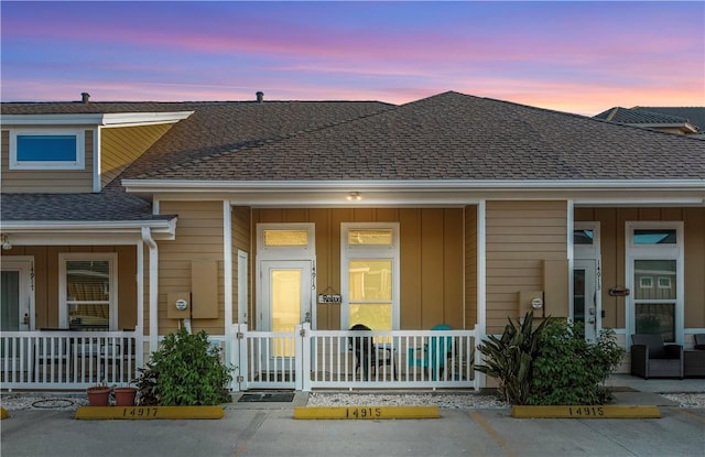 14915 Island Village Dr, Corpus Christi, TX 78418 - townhome / multi-family property with covered porch, uncovered parking, and a shingled roof