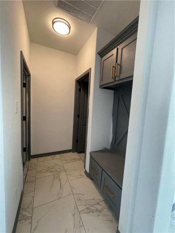 mudroom with visible vents, marble finish floor, and baseboards