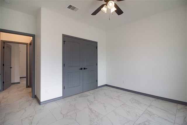 3633 Rebecca Dr, Corpus Christi, TX 78410 - unfurnished bedroom featuring light marble finish floors, baseboards, ceiling fan, and a closet